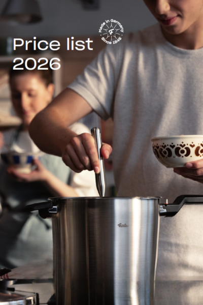 A person cooks with a Fissler stainless steel pot, another holds a bowl. "Price List 2026" and the "Made in Germany" emblem appear above.