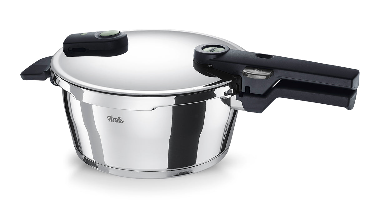 Fissler Vitaquick® Elemental pressure cooker in sage green, with black handle and safety lock, modern design. Made in Germany.